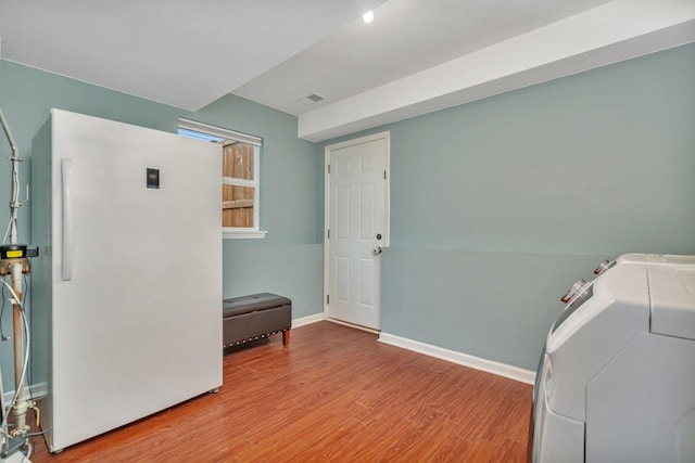 washroom featuring washer / dryer and light wood-type flooring