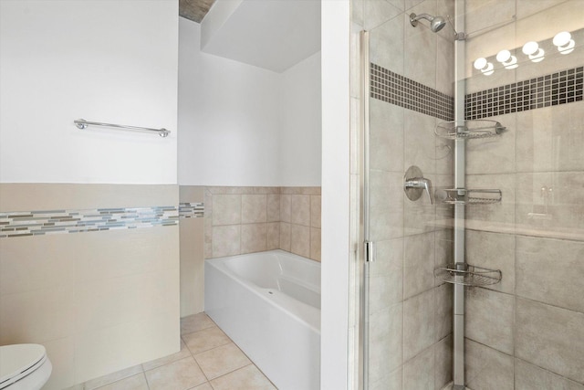 bathroom featuring tile patterned floors, toilet, and plus walk in shower