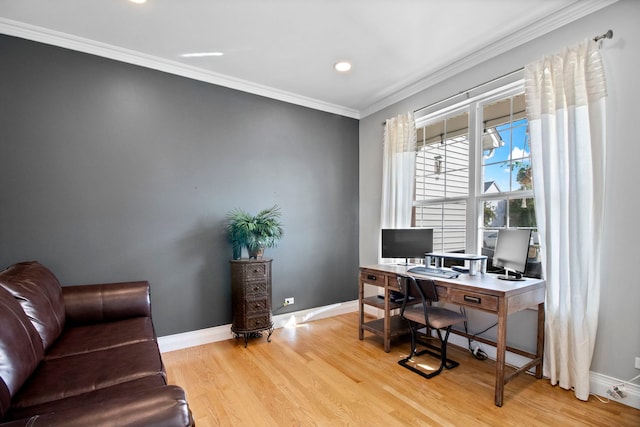 office area with light hardwood / wood-style floors and crown molding