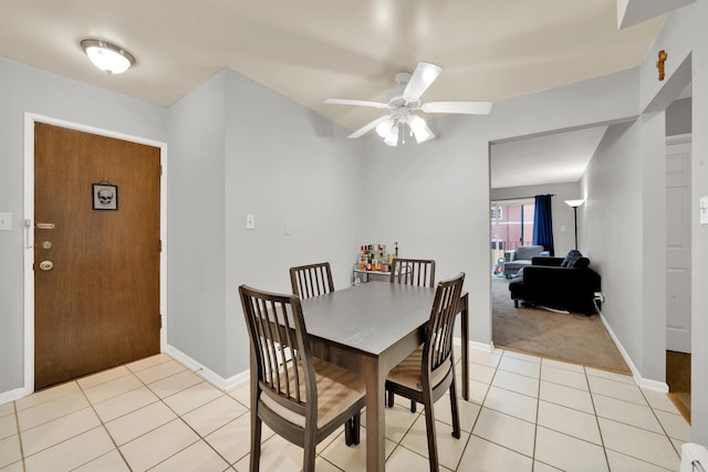 carpeted dining space featuring ceiling fan