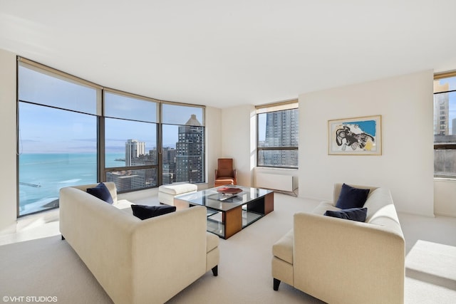 living room with light carpet and a water view