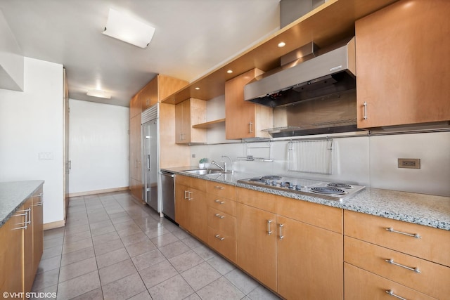 kitchen featuring light stone counters, white gas cooktop, sink, wall chimney range hood, and dishwasher