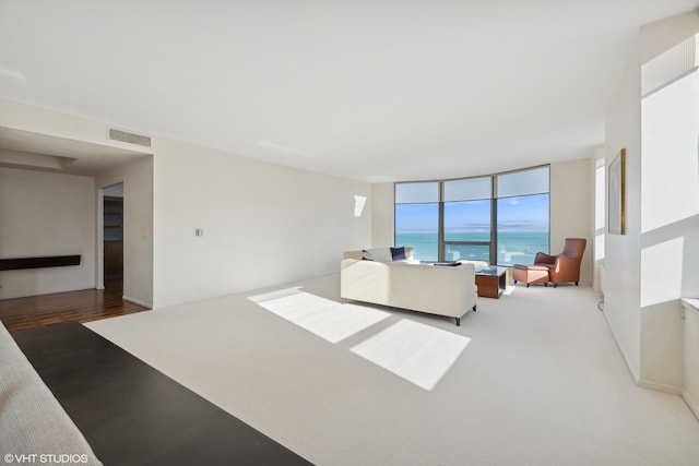 living room with expansive windows and a water view