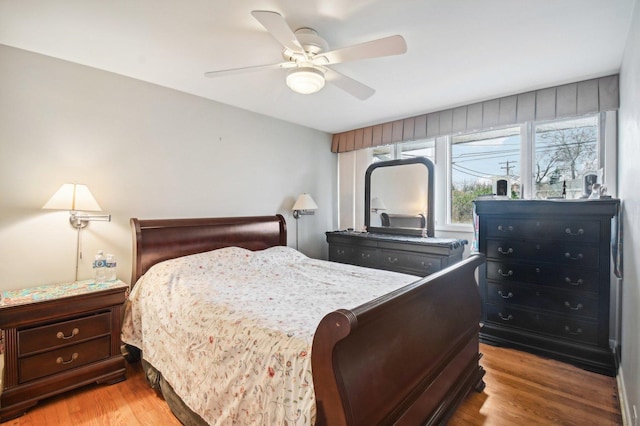 bedroom with ceiling fan and light hardwood / wood-style floors