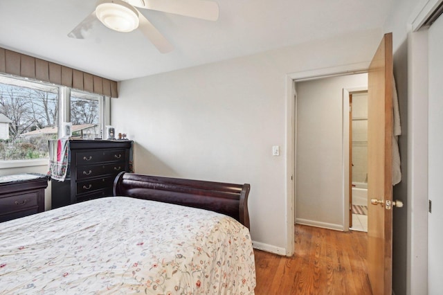 bedroom with hardwood / wood-style floors and ceiling fan