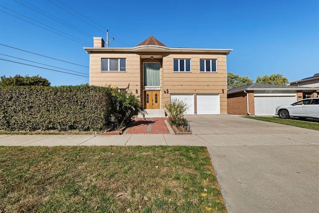 view of front of home with concrete driveway, a chimney, and an attached garage