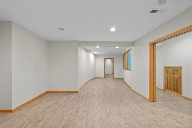 below grade area featuring light wood-type flooring, baseboards, visible vents, and recessed lighting