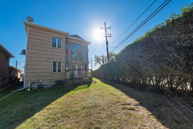 exterior space featuring a lawn and central air condition unit