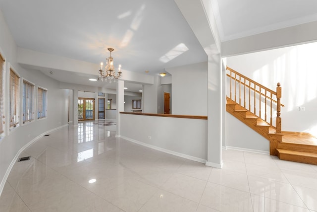 interior space with baseboards, visible vents, stairway, and a chandelier