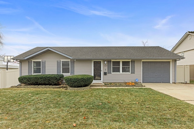 ranch-style home featuring a garage and a front lawn