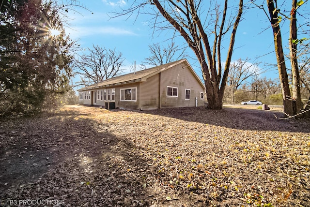 view of side of home with central AC unit