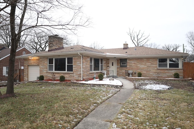 rear view of house with a garage and a yard