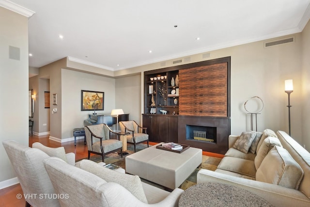 living room with ornamental molding and hardwood / wood-style flooring