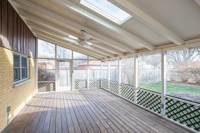 unfurnished sunroom featuring ceiling fan and lofted ceiling with beams