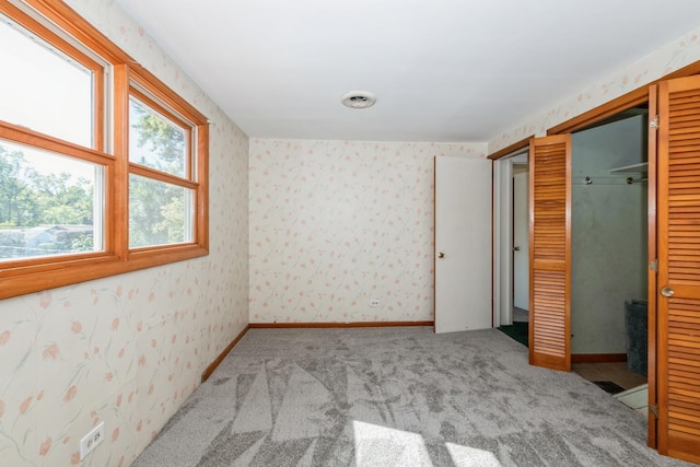 unfurnished bedroom featuring carpet flooring and a closet