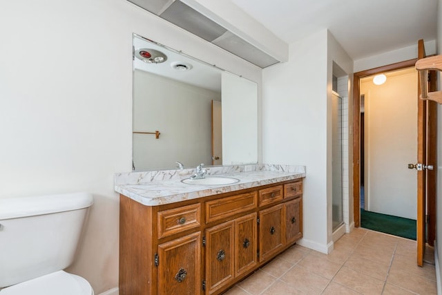 bathroom with walk in shower, tile patterned floors, toilet, and vanity