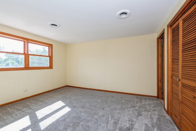 unfurnished bedroom featuring carpet and a closet