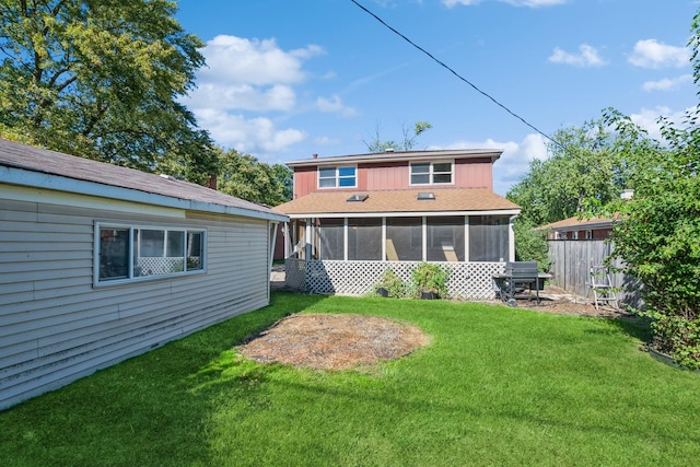 back of house with a yard and a sunroom