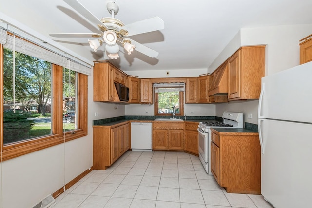 kitchen featuring sink, white appliances, light tile patterned floors, ceiling fan, and custom range hood