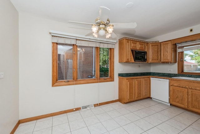 kitchen featuring white dishwasher, sink, light tile patterned floors, and ceiling fan