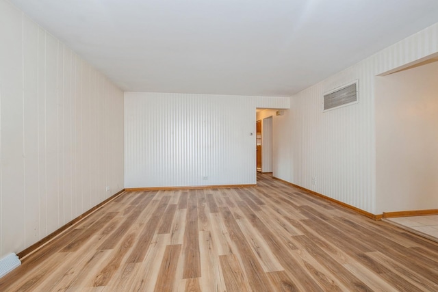 spare room with light wood-type flooring