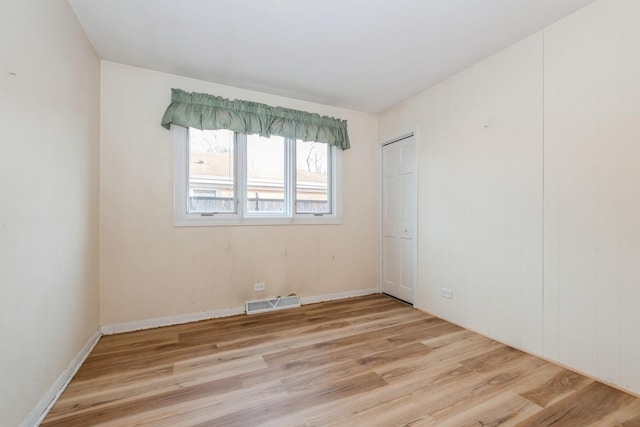 spare room featuring light hardwood / wood-style flooring