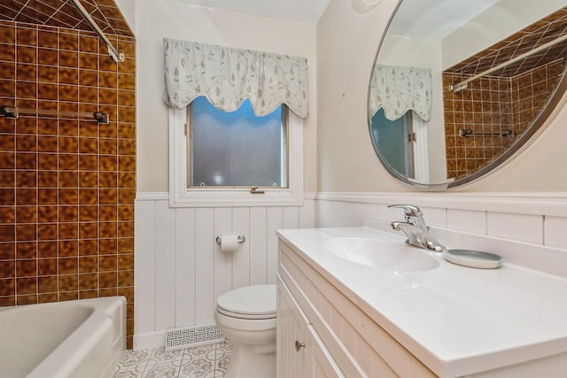 full bathroom featuring tiled shower / bath combo, vanity, tile patterned floors, and toilet