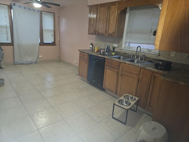 kitchen featuring ceiling fan, sink, light tile patterned floors, and black dishwasher