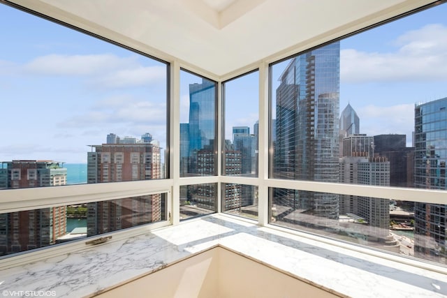 unfurnished sunroom featuring a water view