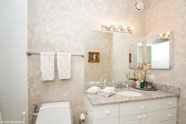 bathroom featuring vanity and toilet