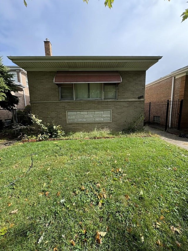 back of house with a lawn