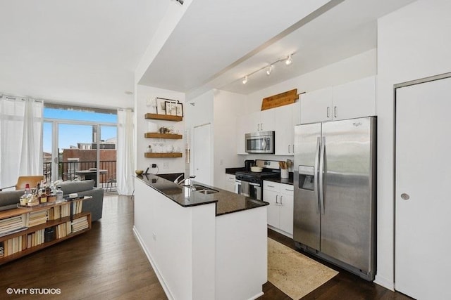 kitchen featuring dark wood-type flooring, floor to ceiling windows, sink, white cabinetry, and appliances with stainless steel finishes