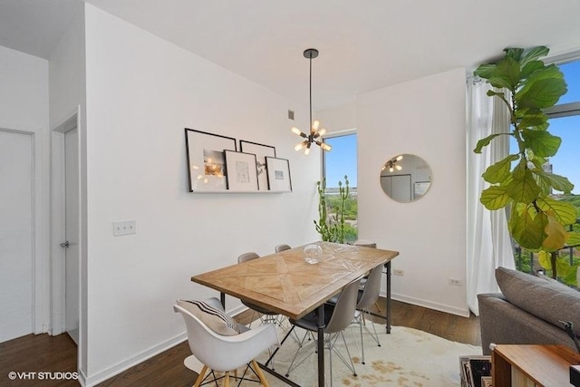 dining room featuring dark hardwood / wood-style floors and a chandelier