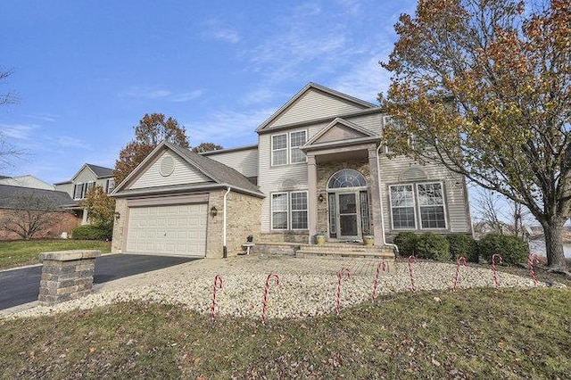 front of property with a front yard and a garage