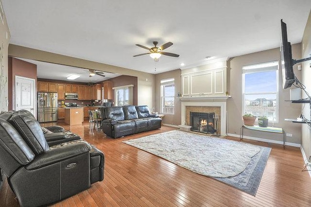 living room with ceiling fan and light hardwood / wood-style floors