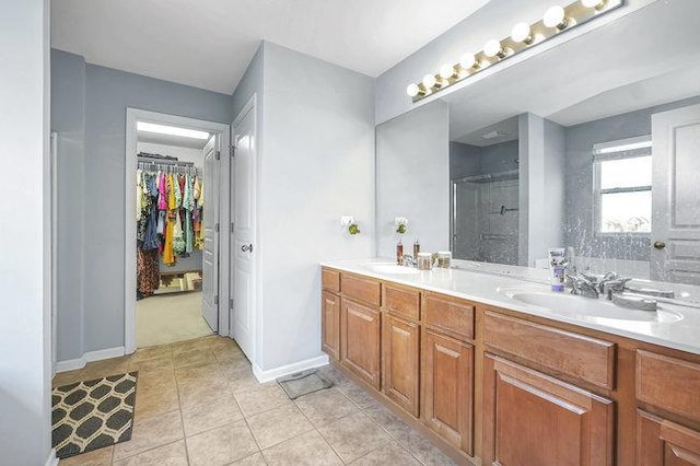 bathroom featuring tile patterned flooring, vanity, and an enclosed shower