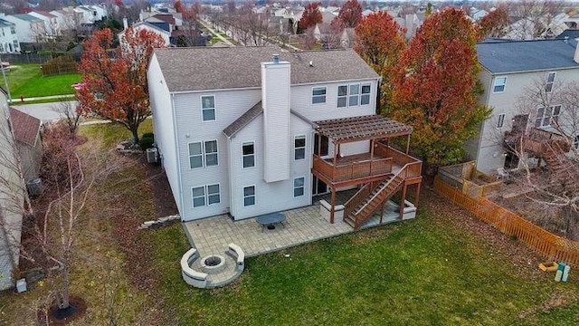 rear view of house featuring a patio area, a yard, and a wooden deck