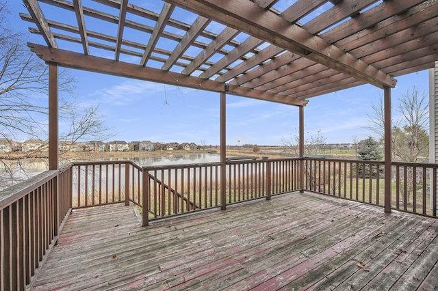 wooden terrace with a pergola and a water view