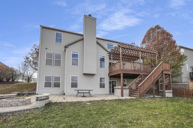 rear view of property with a pergola, a lawn, a patio, and a deck