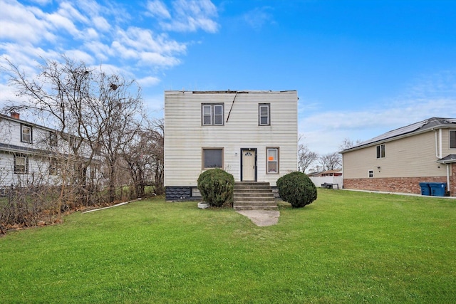 rear view of house featuring a yard