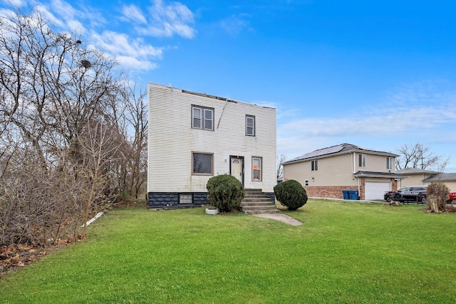 view of front of property with a garage and a front yard