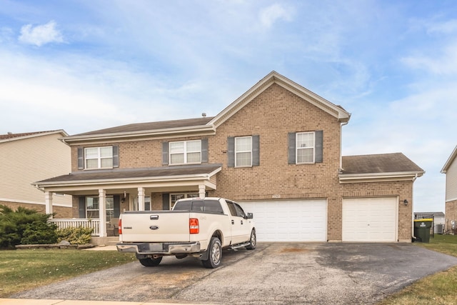 view of front of property with covered porch and a garage