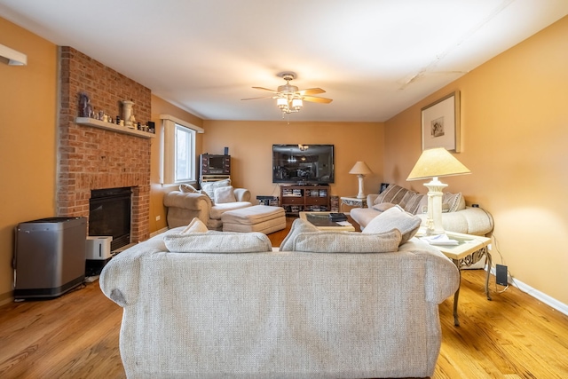 living room featuring ceiling fan and light hardwood / wood-style flooring