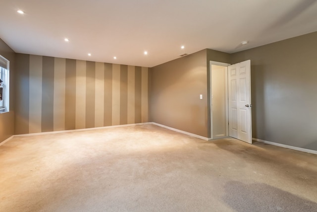 unfurnished room featuring light colored carpet