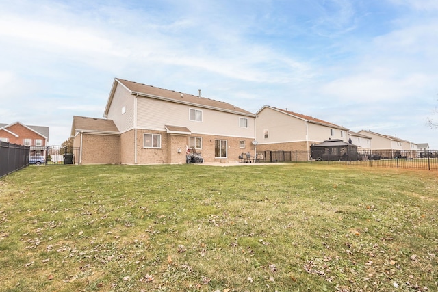 rear view of property featuring a lawn