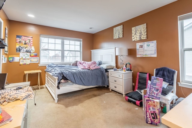 carpeted bedroom with multiple windows