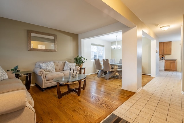 living room featuring light hardwood / wood-style flooring and a notable chandelier