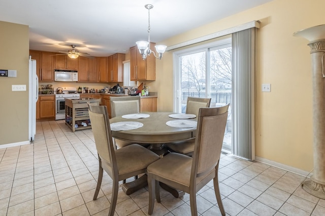 dining room with ceiling fan with notable chandelier and light tile patterned flooring