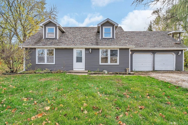 new england style home with a front yard and a garage