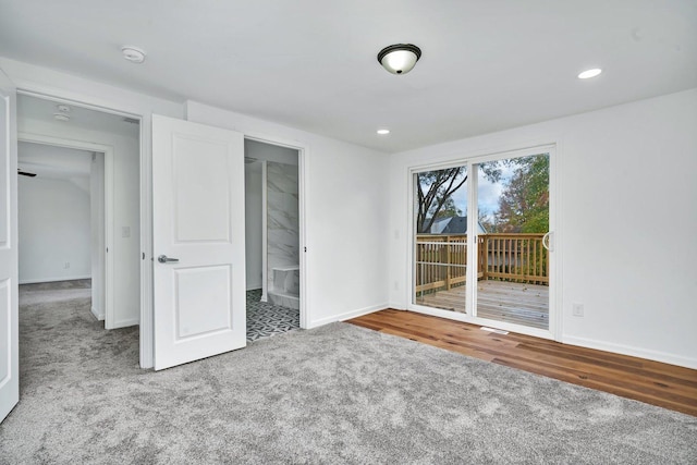 unfurnished bedroom featuring carpet floors and access to outside